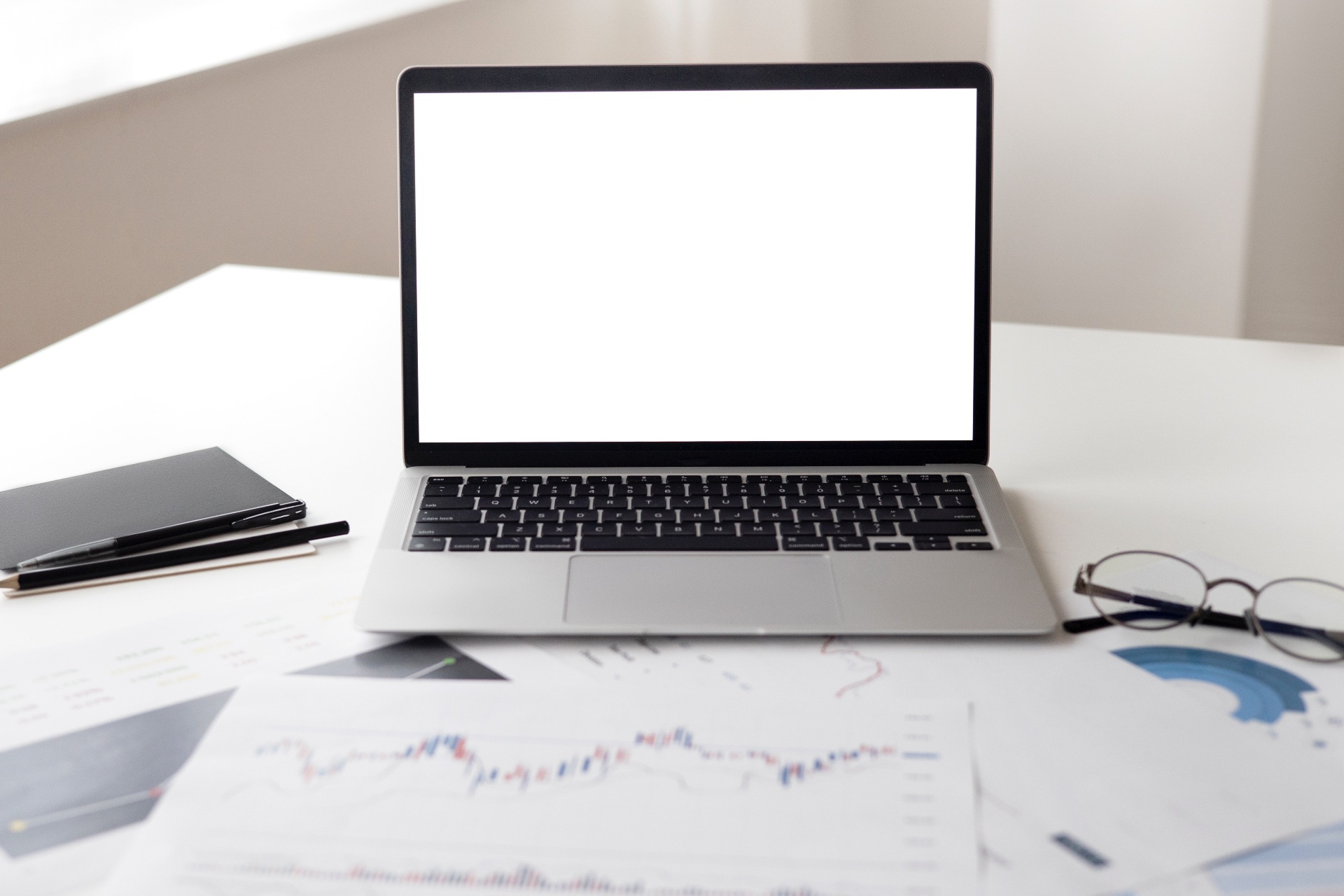 A laptop and a piece of paper in front with analysis